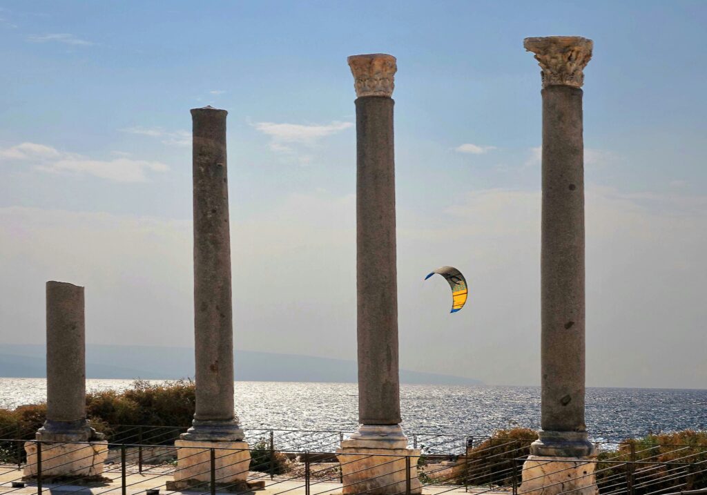 Stone columns of the ancient ruins of Tyre, Lebanon, standing along the Mediterranean coast with the sea in the background.