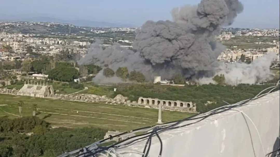 Explosion and large plume of smoke visible near the Al-Bass Archaeological Site in Tyre, Lebanon, a UNESCO World Heritage site.