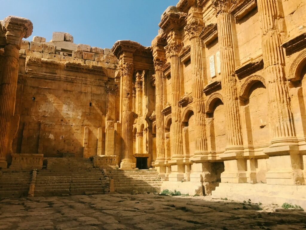 Ancient Roman temple ruins with tall columns and carved stone façade at Baalbek, Lebanon