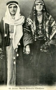 Historic photograph of a newly married Bedouin Christian couple wearing traditional attire and jewelry.