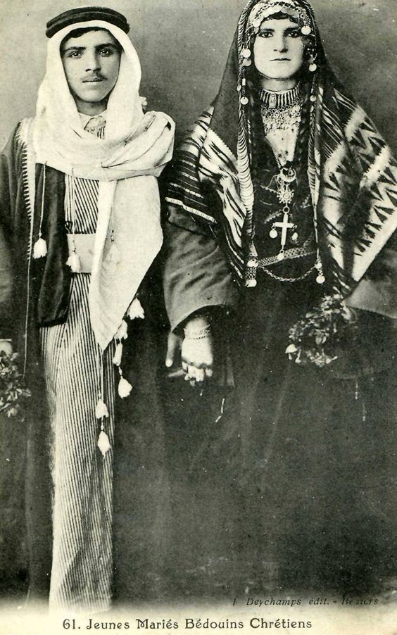 Historic photograph of a newly married Bedouin Christian couple wearing traditional attire and jewelry.