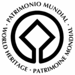 UNESCO World Heritage emblem with circular symbol and central diamond.