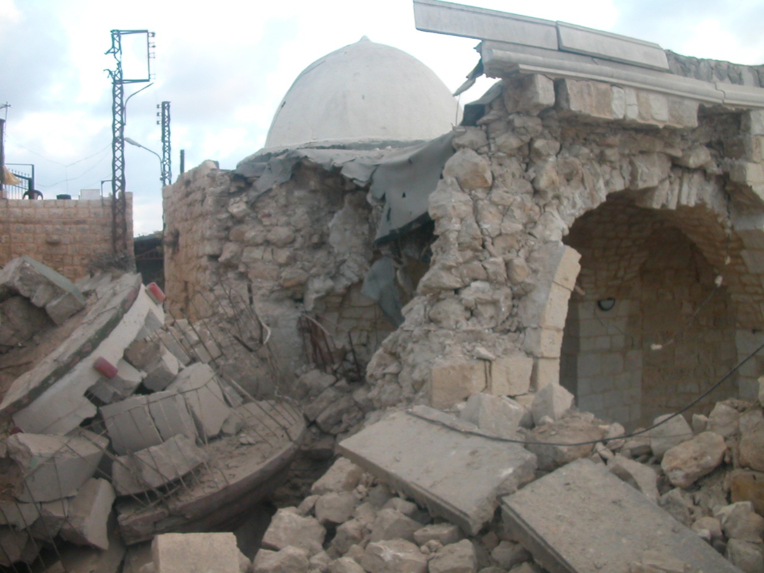 Damaged historic stone structure with collapsed walls and dome at Chamaa site in Lebanon